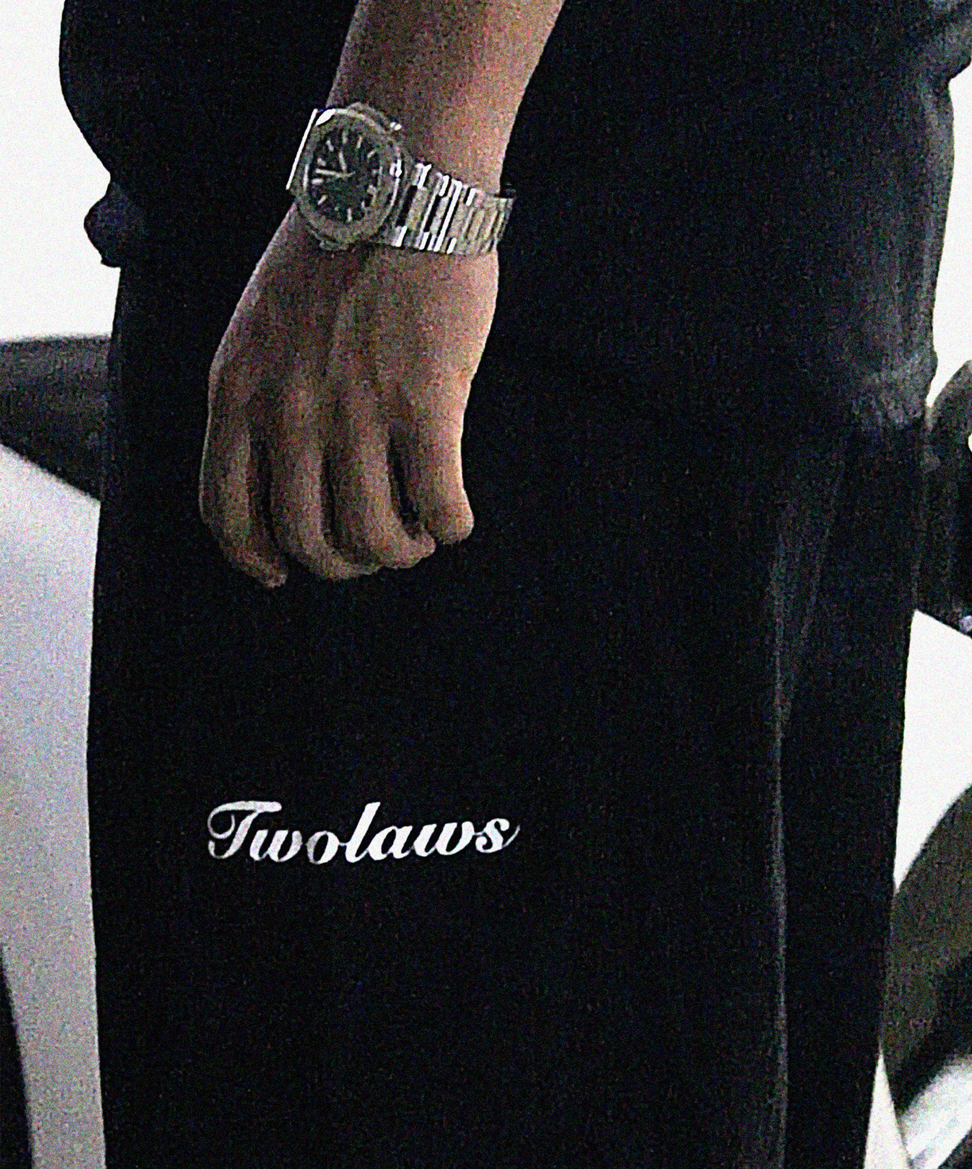 Model wearing TWOLAWS Black Cargo Pants showing utility pockets and tailored fit.